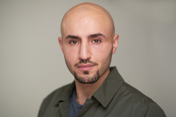 Fototapeta premium Portrait of bald man with green shirt in studio