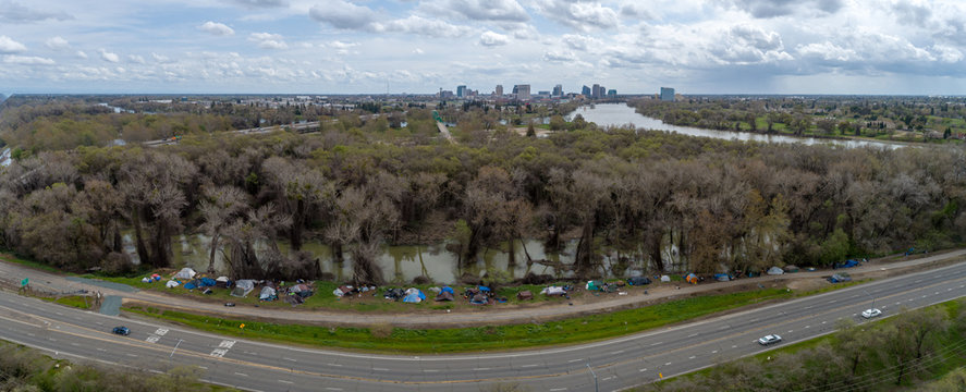 Aerial image of homeless tents along the rising river in Sacramento.