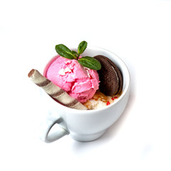 Ice cream decorated with mint and sweets in a cup on an isolated white background