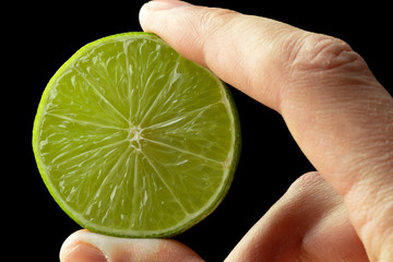 Half lime in the hand of a man.