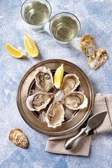 Fototapeta na wymiar Fresh ocean oysters with slices of lemon on ice. 
