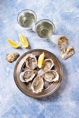 Fresh ocean oysters with slices of lemon on ice. 