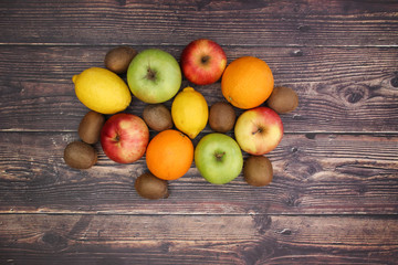 Obraz na płótnie Canvas Healthy lifestyle - fruits and vegetables on wooden background
