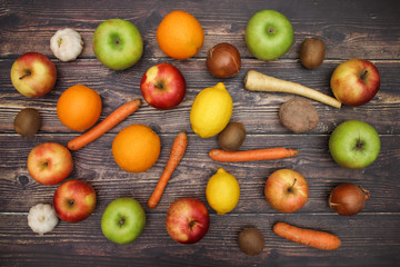 Healthy lifestyle - fruits and vegetables on wooden background