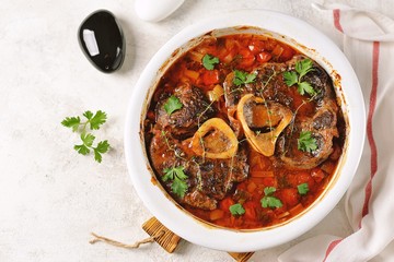 Beef shank stew with onions, carrots, celery, tomatoes, thyme and wine. Top view.