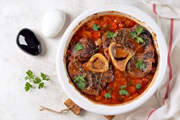 Beef shank stew with onions, carrots, celery, tomatoes, thyme and wine. Top view.
