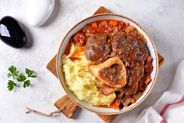 Beef shank stew with onions, carrots, celery, tomatoes, thyme and wine. Top view.