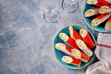 Crab sticks stuffed with soft cheese, boiled egg, garlic, mayonnaise and dill. Festive Russian snack. Top view.  © chudo2307
