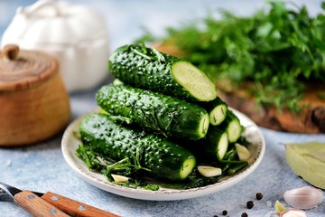 Homemade cucumbers quick salting with dill, garlic and bay leaf. Organic food.