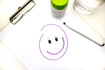 Fake happiness concept. Happy smiling face with pills eyes. Drugs addiction.