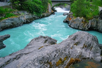 Aqua Color River in Loom Norway with stone arched bridge