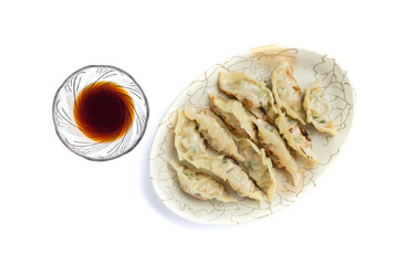 Dumplings or gyoza with soy sauce isolated on white background