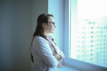 Executive business woman looking out the office window