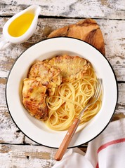 meat pieces fried in a mixture of flour and eggs with spaghetti