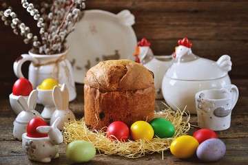 Traditional Easter food - eggs and Easter cake on an old wooden table. Easter background.