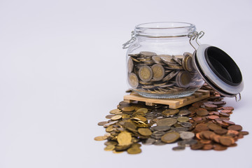 Jar of Euro coins on clear paper background 