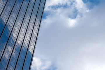 Fototapeta na wymiar Industrial business building glass reflecting blue sky and clouds on a new york city day