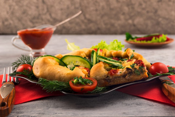 Mini pizza, cut into pieces. Sliced ​​cucumber and tomato. Spicy tomato sauce. Quick and tasty dinner.