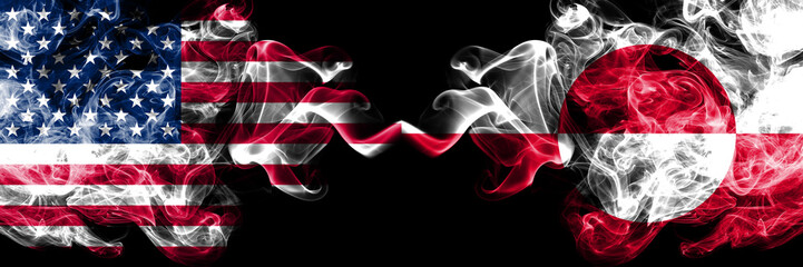 United States of America vs Greenland smoky mystic flags placed side by side. Thick colored silky smoke flags of America and Greenland