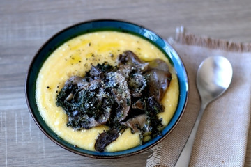 Fried mushrooms and polenta with cheese and chicory. Selective focus.