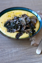 Fried mushrooms and polenta with cheese and chicory. Selective focus.