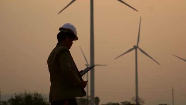 Senior Engineer, Asian are monitoring system wind turbine electricity generation with teblet footage 4K
