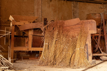 Fototapeta na wymiar A barn in an old farm. Old machines helpful in agriculture.