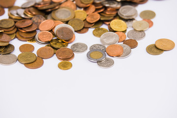 Heap of colorful coins on clear background