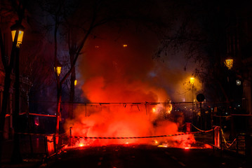 Naklejka premium Colorful mascleta full of firecrackers and fireworks with lots of smoke and sparks.