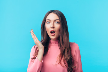 Shocked amazing woman isolated on blue background