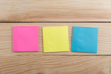 Many colorful sticky note on wooden desk. Copy space