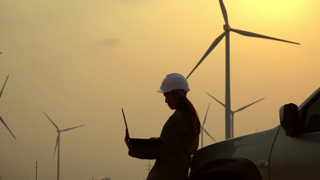 Senior Engineer, Asian are monitoring system wind turbine electricity generation with teblet footage 4K