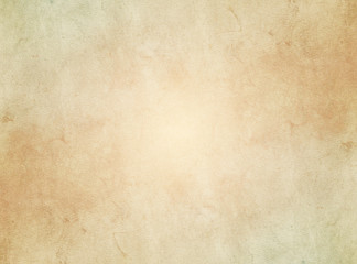 Fototapeta na wymiar An elegant, beige, tan, grunge parchment texture background with glowing center. 