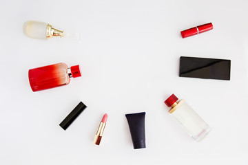 Obraz premium Bag with woman's cosmetics. Women's secrets. Cosmetics in woman's hands. Care creams. Bottles with cosmetics, lipstick, parfume, red accents