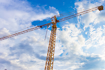 buildings under construction and cranes under a blue sky
