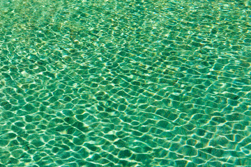 Green swimming pool rippled water detail