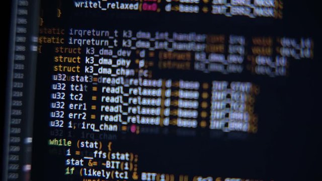 The program code scrolls on the computer screen