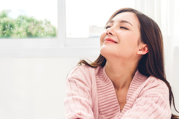 Woman feeling happy and relaxed breathing fresh air at morning