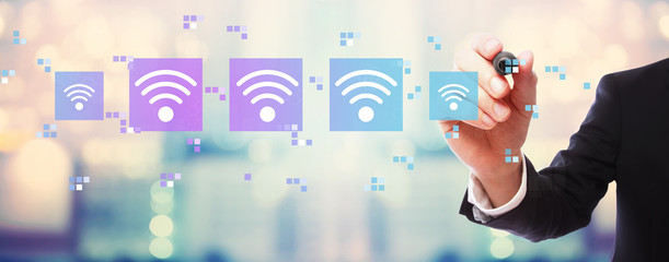Fototapeta na wymiar Wifi concept with businessman on blurred abstract background