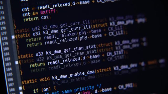The program code scrolls on the computer screen
