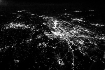 Flying at night over cities below