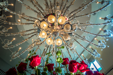 Chandelier hanging over lobby with stair and luxury hall