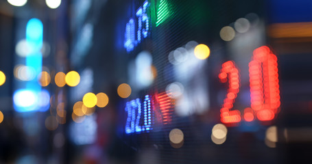 Stock market display screen in city at night