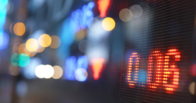 Stock market display screen in city at night