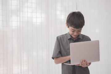 Asian students boy using laptop learning in the classroom at school