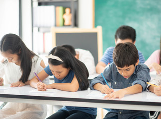 Asian primary student and teacher in the classroom