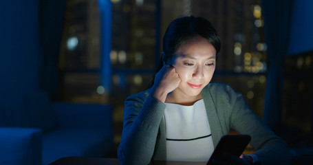 Woman use of cellphone at night