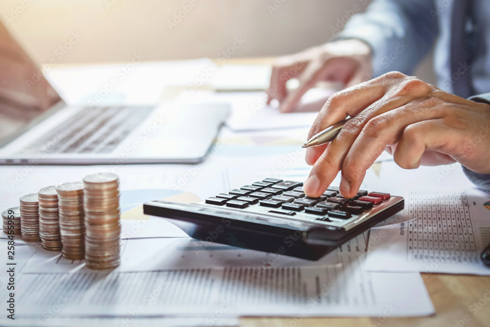Poster businessman working on desk with using calculator for calculate finance and accounting in office