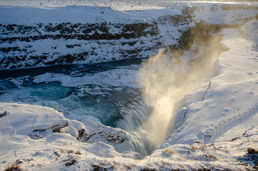 Mist coming off waterfall during winter in Iceland