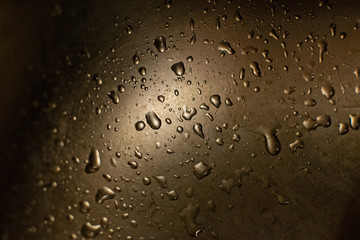 Abstract water drops on stainless steel close up.